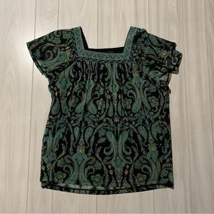 green and black patterned blouse